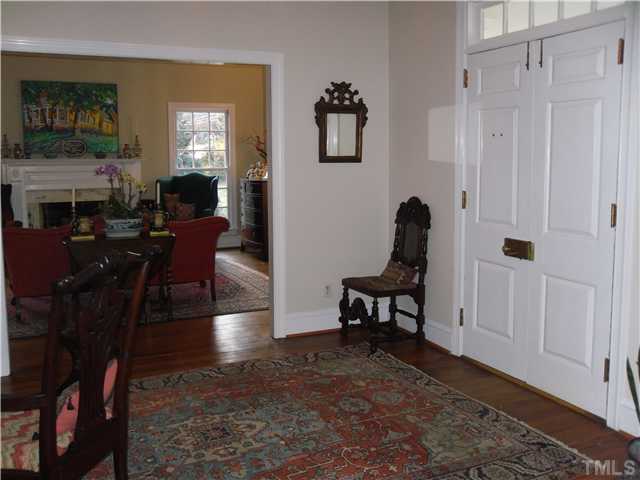 2406 Anderson Drive Raleigh, NC 27608 - Photo 9 of 25 a living room with furniture a fireplace and a window