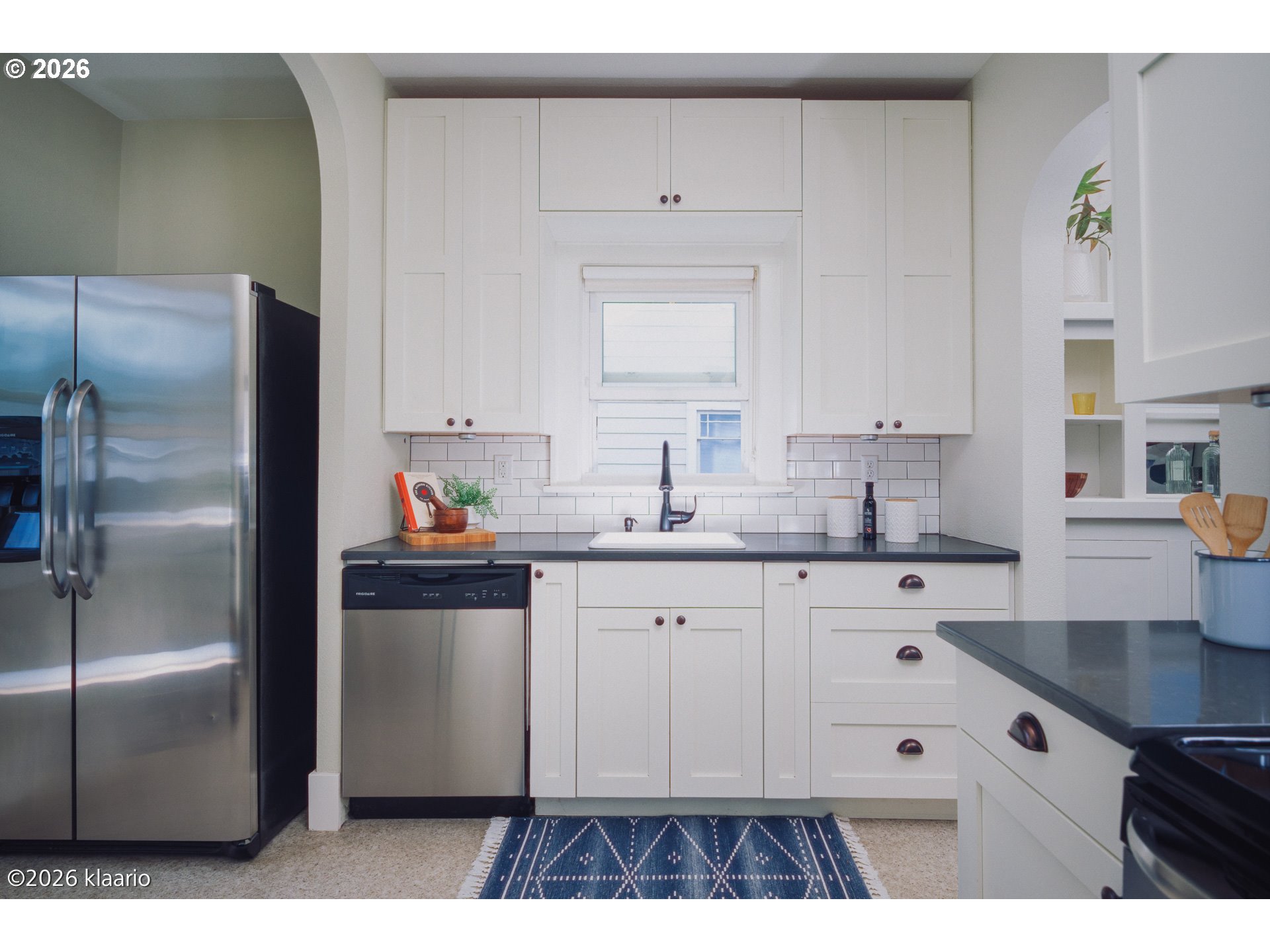1253 North Baldwin Street Portland, OR 97217 - Photo 8 of 30 a kitchen with a refrigerator sink and cabinets