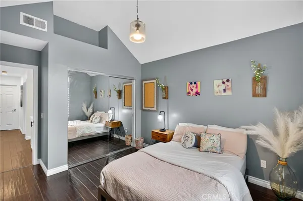 a bedroom with a bed and wooden floor