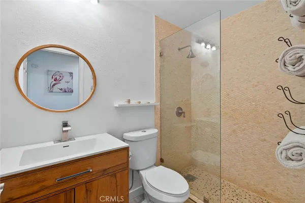 a bathroom with a sink mirror vanity and toilet