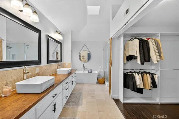 a spacious bathroom with a double vanity sink and a mirror