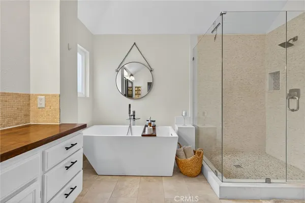 a bathroom with a tub sink and mirror