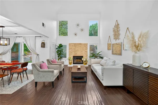 a living room with furniture fireplace and window
