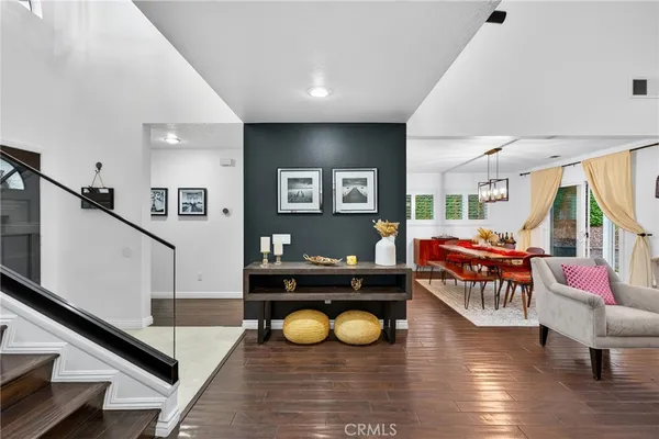 a living room with furniture and a pool table