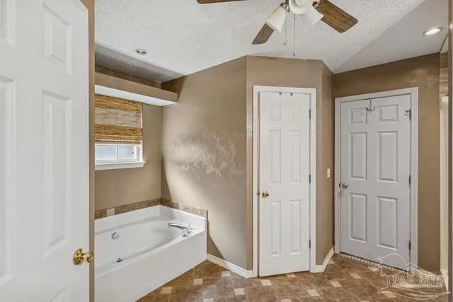 a bathroom with a tub shower and sink