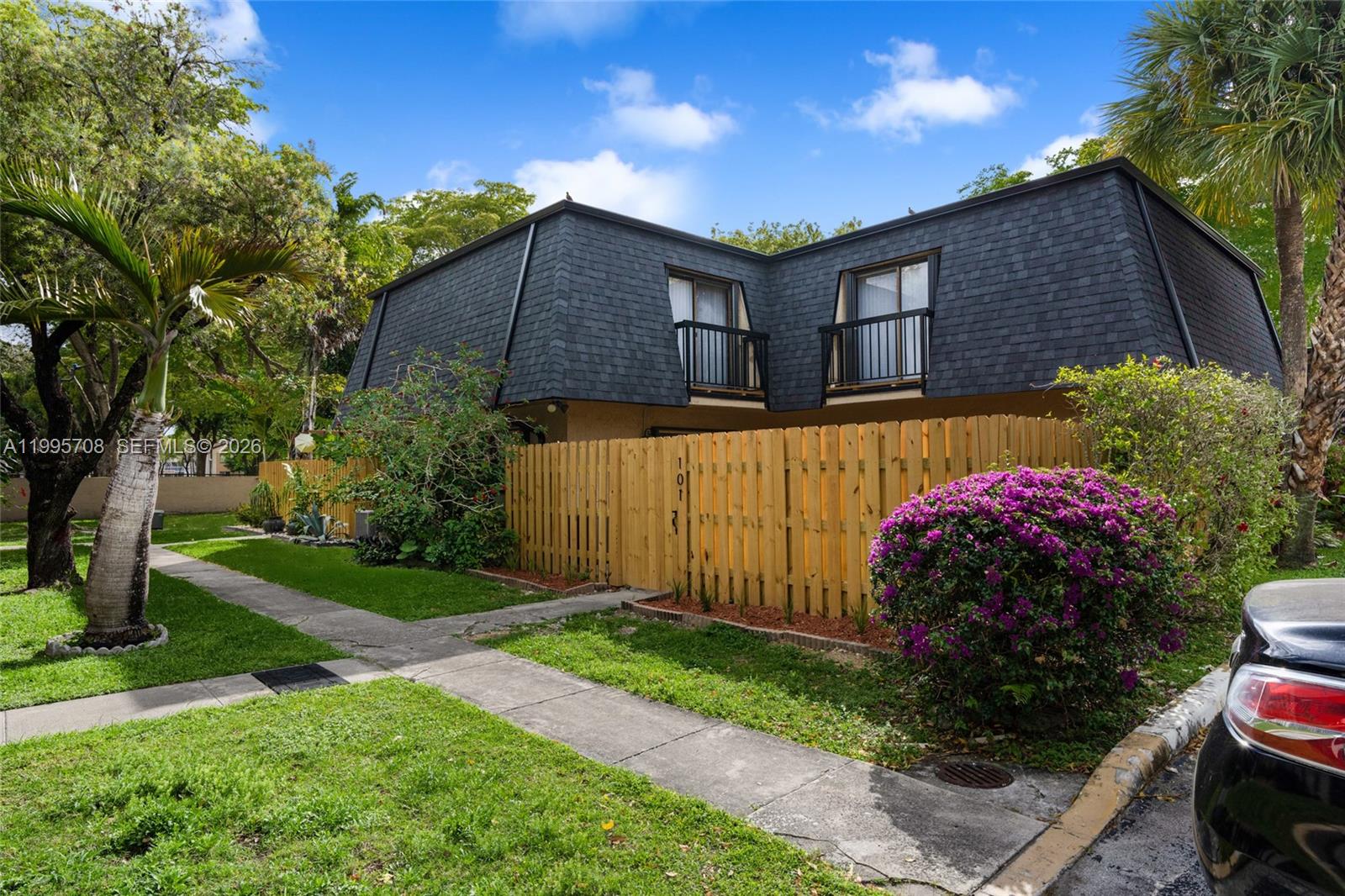 13993 Southwest 94th Cir Lane, Unit 1013 Miami, FL 33186 - Photo 1 of 36 a front view of a house with garden