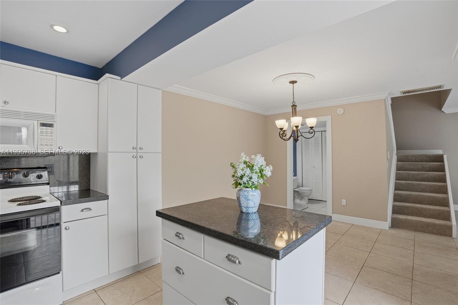 13993 Southwest 94th Cir Lane, Unit 1013 Miami, FL 33186 - Photo 15 of 36 a kitchen with stainless steel appliances granite countertop a sink a stove and a refrigerator