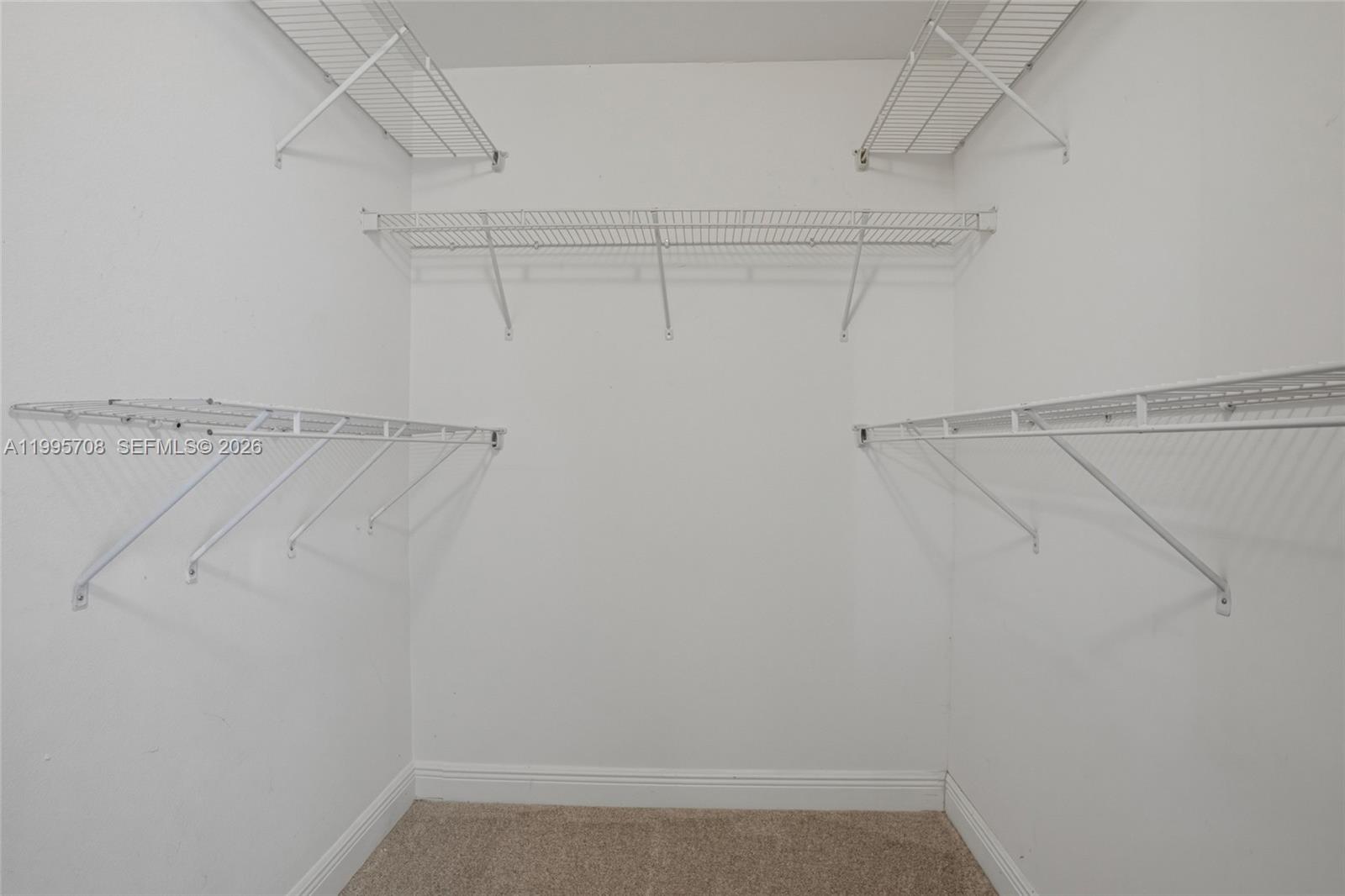 13993 Southwest 94th Cir Lane, Unit 1013 Miami, FL 33186 - Photo 21 of 36 a view of a room with racks on the wall
