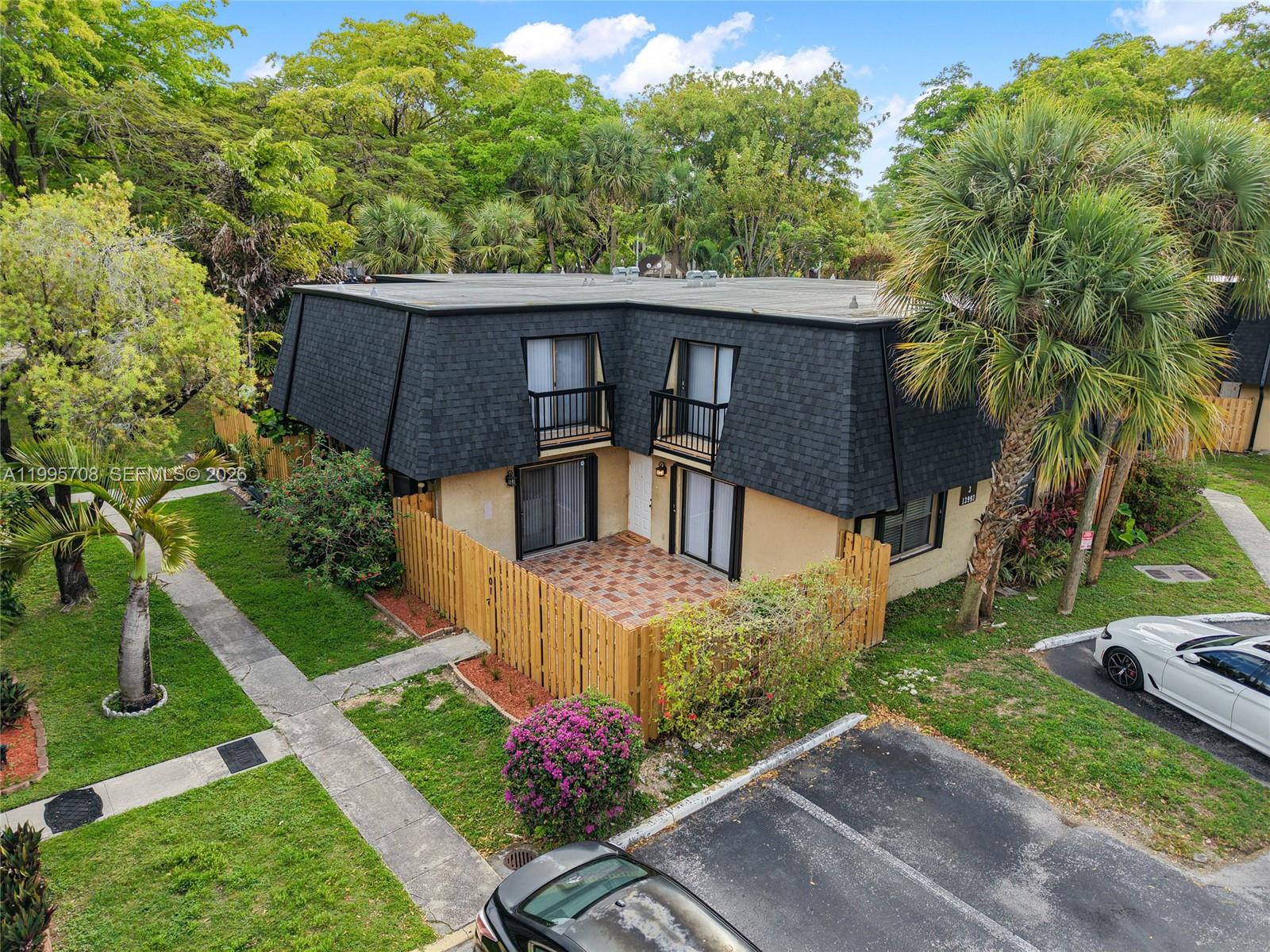 13993 Southwest 94th Cir Lane, Unit 1013 Miami, FL 33186 - Photo 30 of 36 a view of a house with a yard plants and a fountain