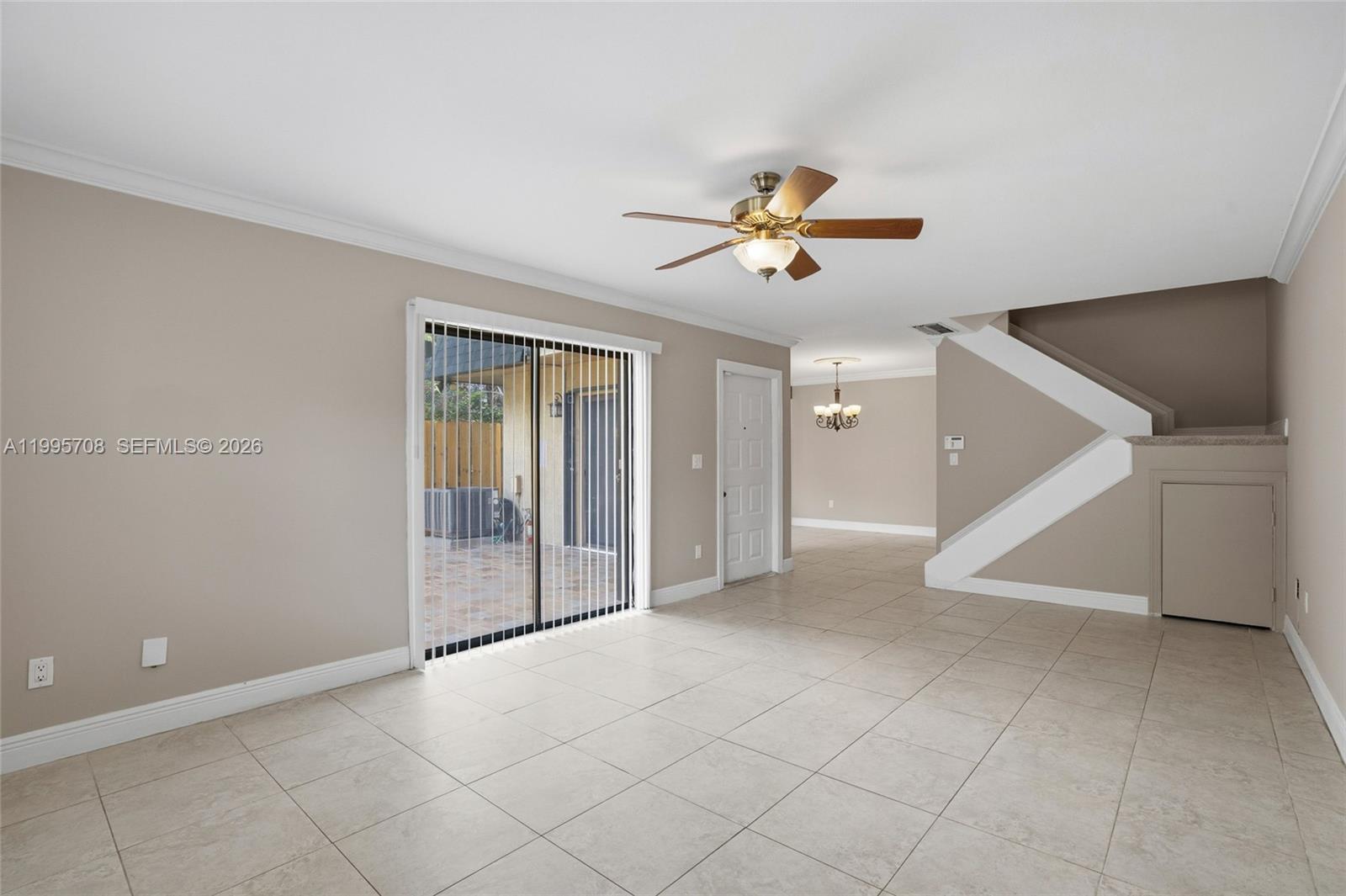 13993 Southwest 94th Cir Lane, Unit 1013 Miami, FL 33186 - Photo 6 of 36 a view of a livingroom with a ceiling fan and window