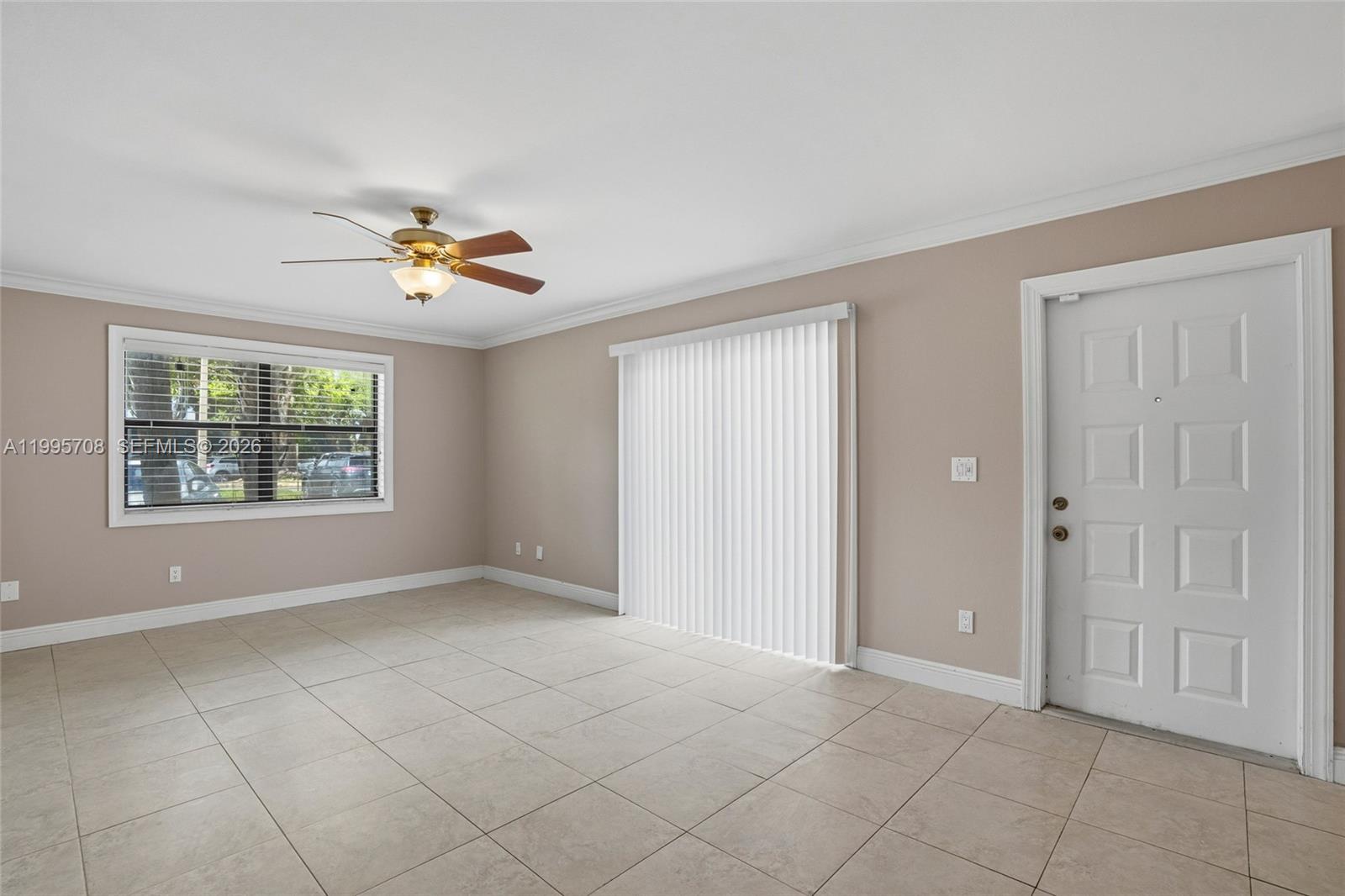 13993 Southwest 94th Cir Lane, Unit 1013 Miami, FL 33186 - Photo 7 of 36 an empty room with windows and chandelier fan