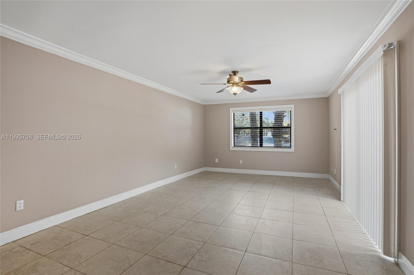 13993 Southwest 94th Cir Lane, Unit 1013 Miami, FL 33186 - Photo 8 of 36 an empty room with windows and chandelier fan