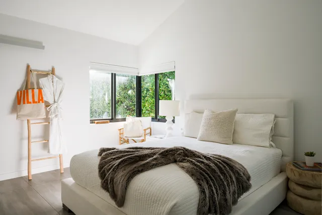 a bedroom with a bed and a large window