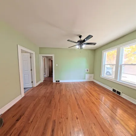 a workspace with wooden floor and ceiling fan