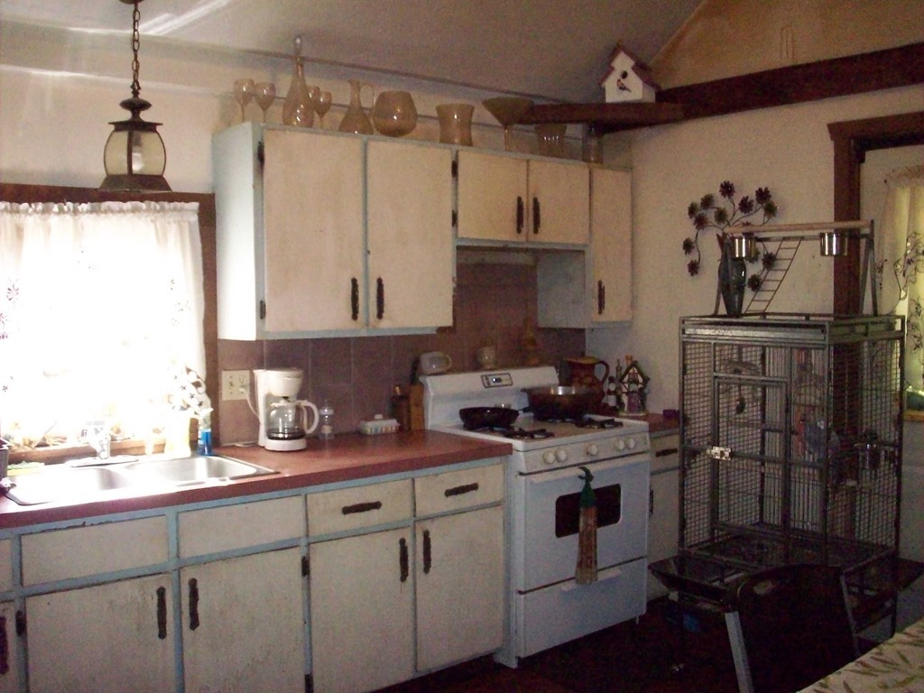 49 South Sturbridge Road Charlton, MA 01507 - Photo 17 of 30 a kitchen with a sink stove and cabinets