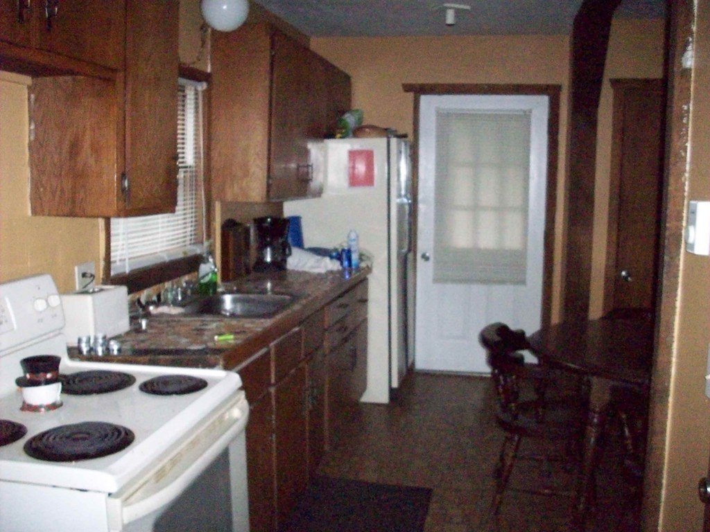 49 South Sturbridge Road Charlton, MA 01507 - Photo 7 of 30 a kitchen with sink a refrigerator and chairs