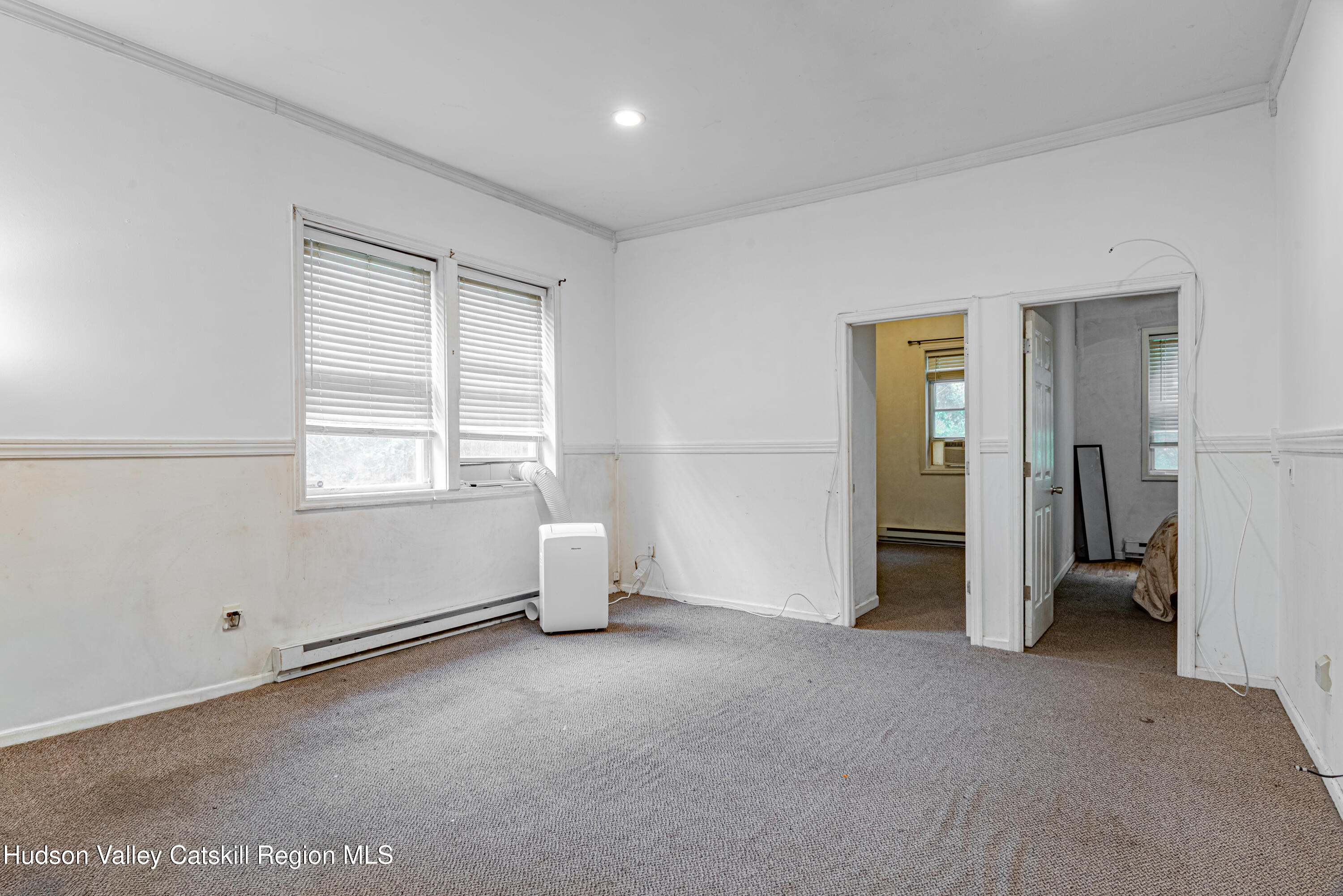 233 Rossway Road Pleasant Valley, NY 12569 - Photo 11 of 22 an empty room with a window and a kitchen