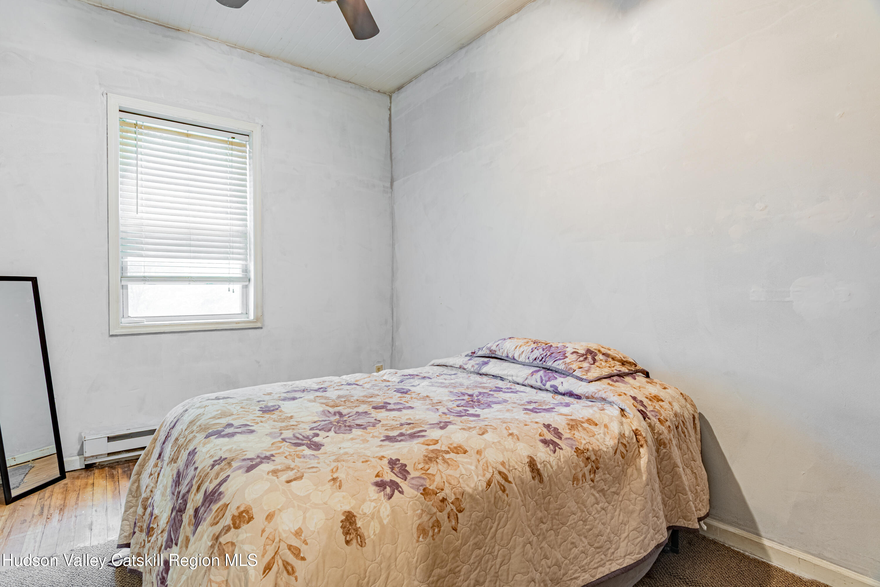 233 Rossway Road Pleasant Valley, NY 12569 - Photo 15 of 22 a bed sitting in a bedroom next to a window