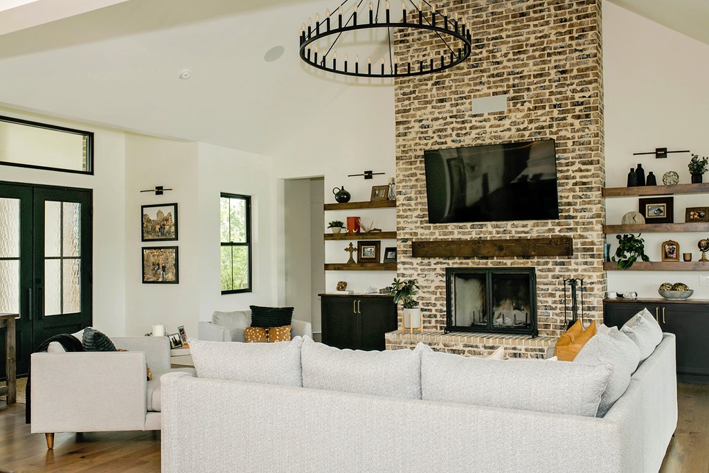 674 Windmill Ridge Drive Blanco, TX 78606 - Photo 7 of 13 a living room with furniture a flat screen tv and a fireplace