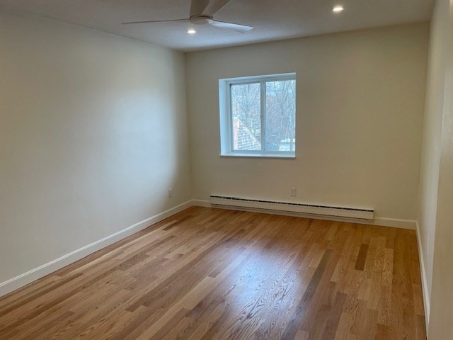 25 Custer Street, Unit 303 Boston, MA 02130 - Photo 4 of 8 a view of a room with wooden floor and a window