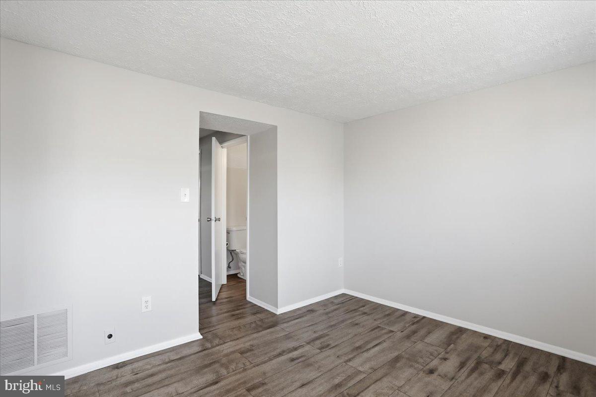 6734 Fallow Hill Court Frederick, MD 21703 - Photo 13 of 29 a view of an empty room with wooden floor and closet