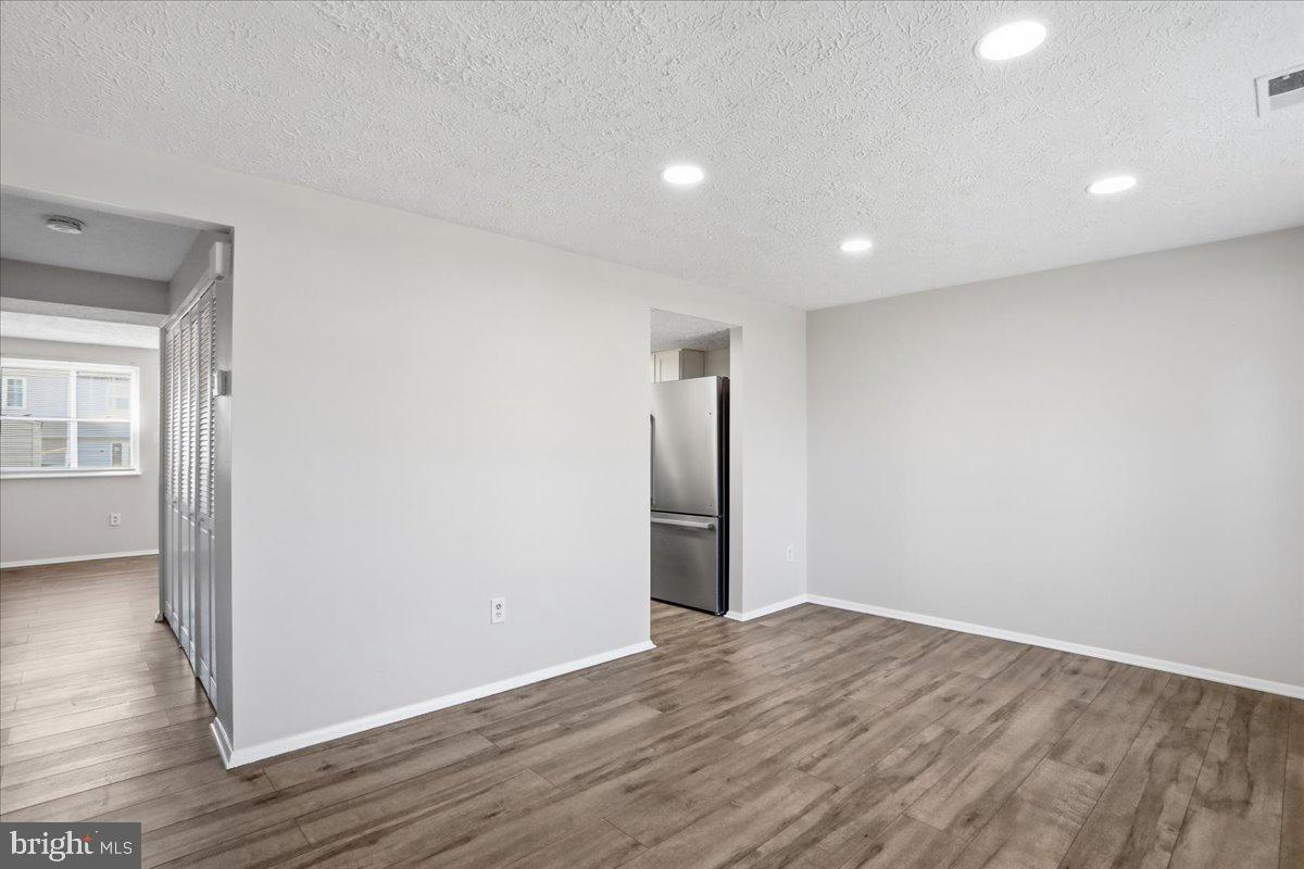 6734 Fallow Hill Court Frederick, MD 21703 - Photo 4 of 29 a view of an empty room with wooden floor and closet