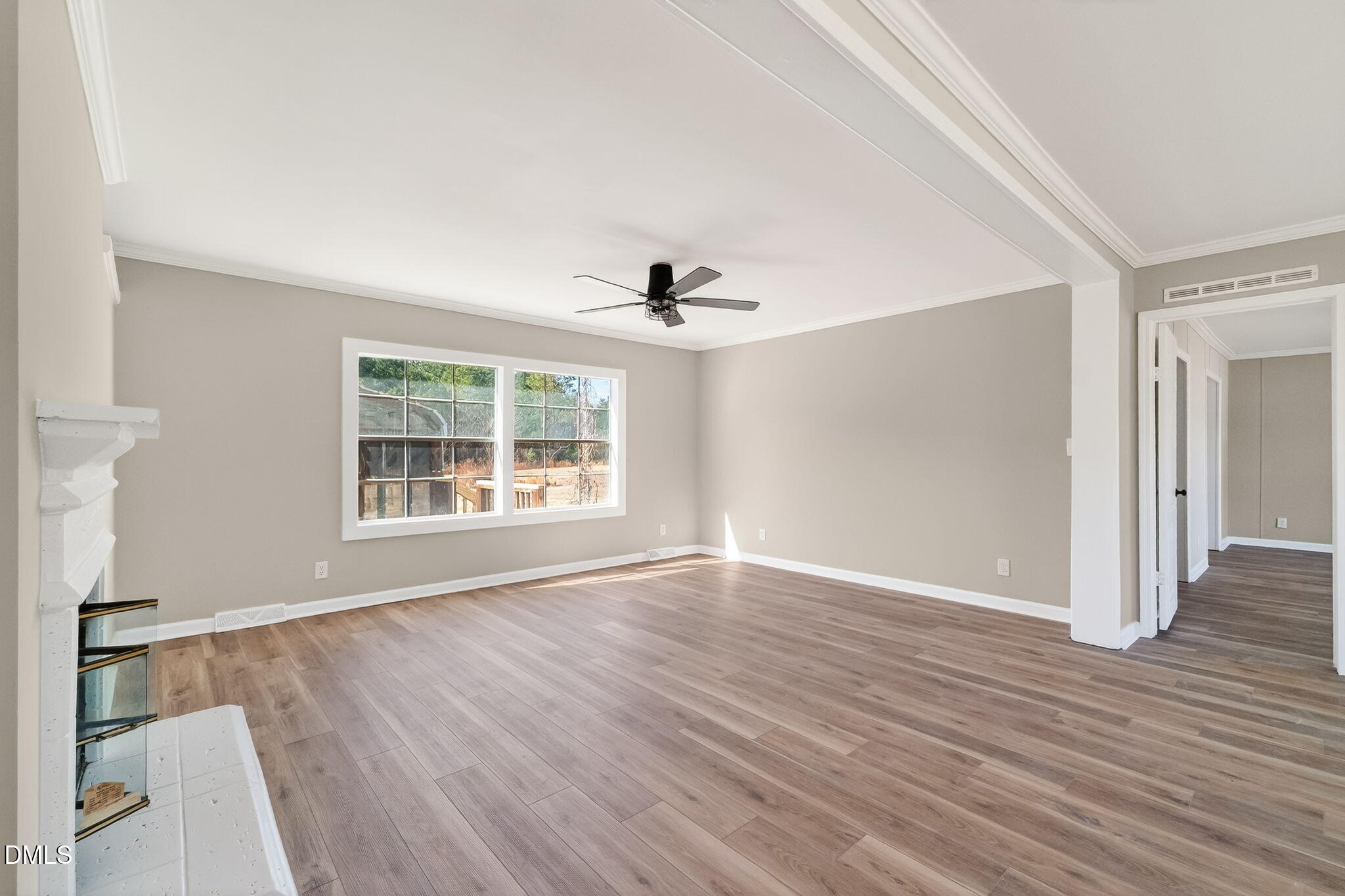 10015 Smith Road Middlesex, NC 27557 - Photo 10 of 48 a view of an empty room with wooden floor and a window