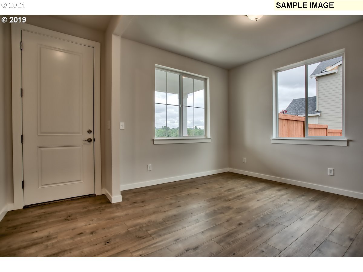 North Mccanta Way Ridgefield, WA 98642 - Photo 6 of 12 an empty room with wooden floor and windows