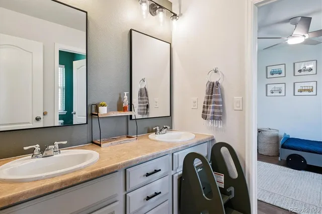 a bathroom with a double vanity sink and a mirror