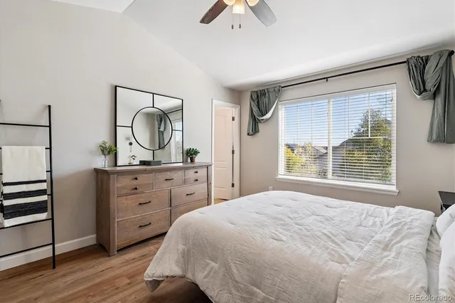 a spacious bedroom with a bed and a dresser