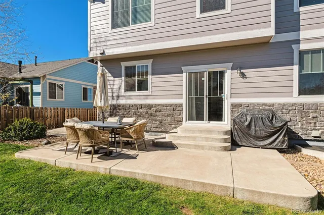 a view of a patio with table and chairs and a fire pit
