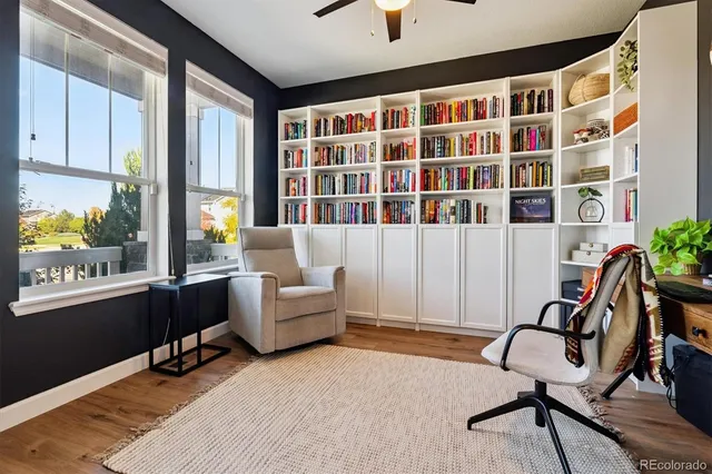 a view of a workspace with furniture and a window