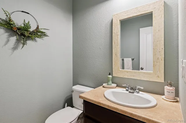 a bathroom with a sink toilet and a mirror