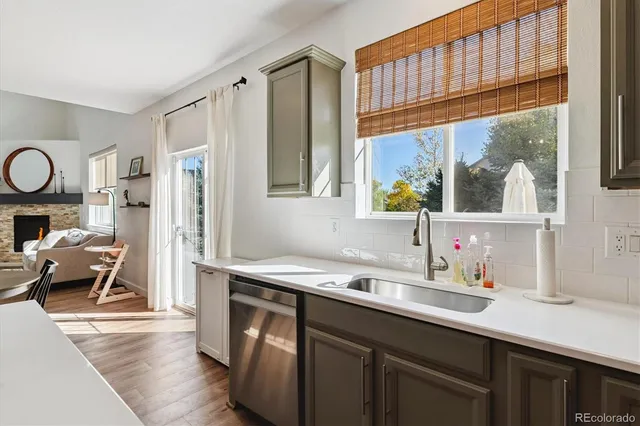 a kitchen with a sink cabinets and a window