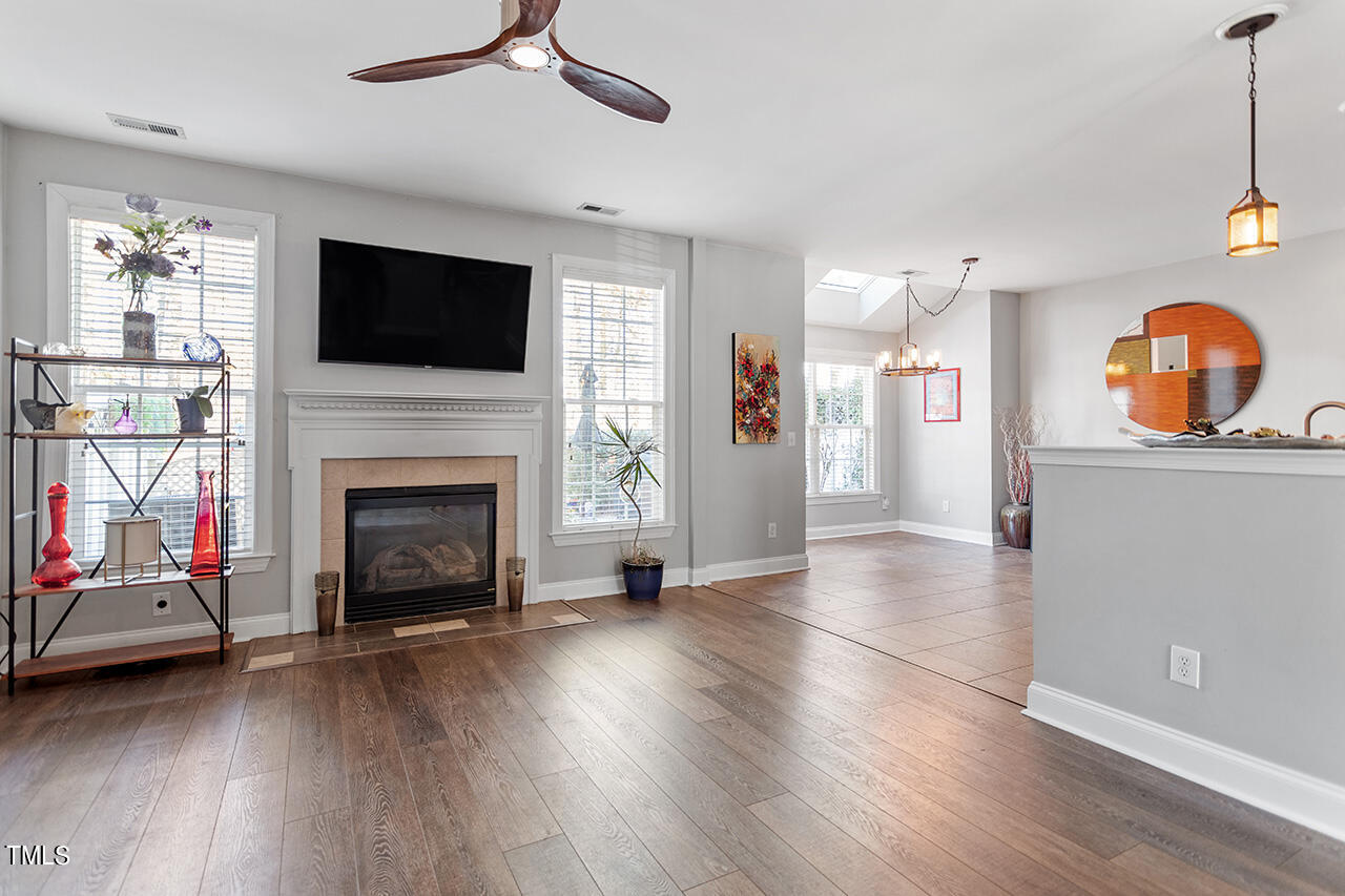 10145 Mizner Lane Raleigh, NC 27617 - Photo 11 of 61 Gas log fireplace and LVP flooring in spacious family room