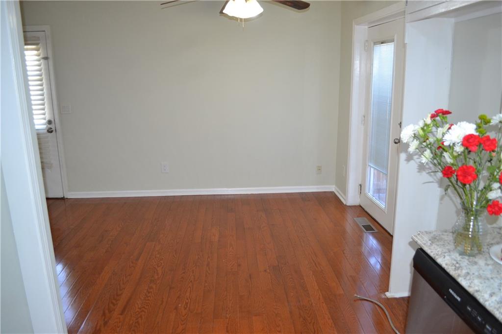 555 Lee Byrd Road Loganville, GA 30052 - Photo 13 of 23 a workspace with wooden floor