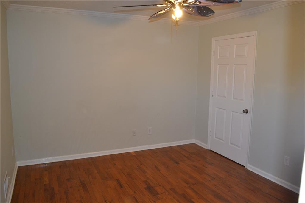 555 Lee Byrd Road Loganville, GA 30052 - Photo 19 of 23 a view of an empty room with wooden floor