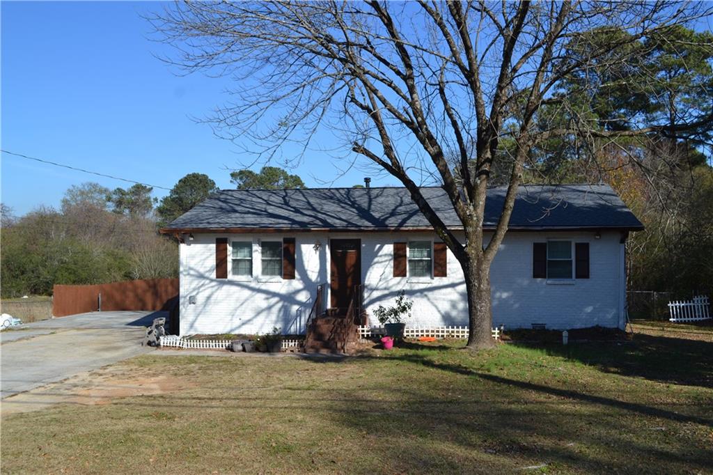 555 Lee Byrd Road Loganville, GA 30052 - Photo 2 of 23 a view of a house with a yard