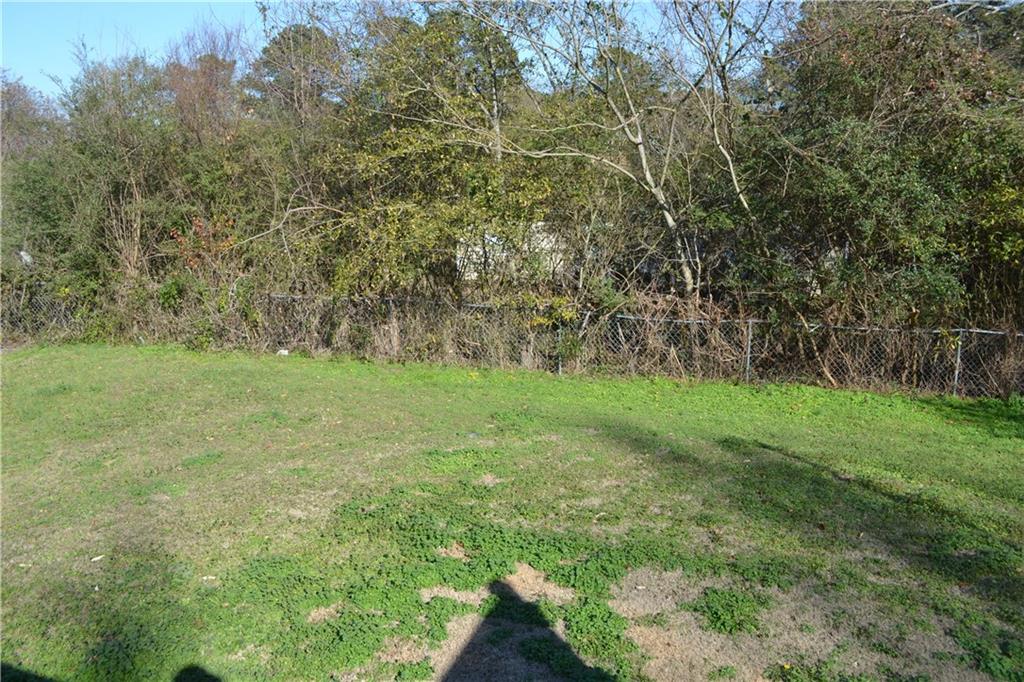 555 Lee Byrd Road Loganville, GA 30052 - Photo 7 of 23 a view of a green yard with large trees