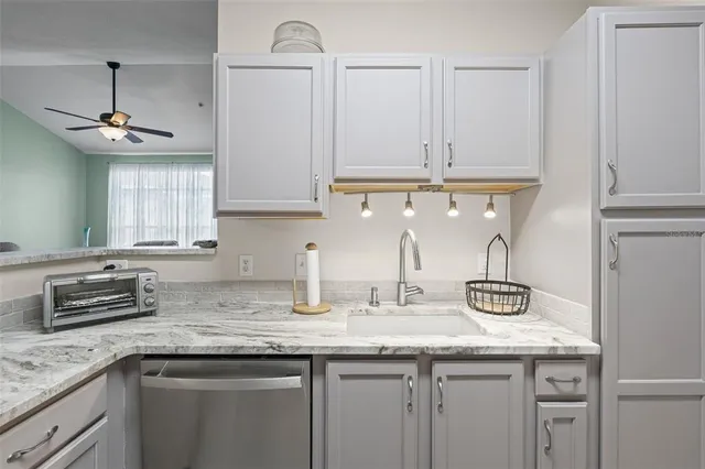 a living room with furniture a chandelier and a window