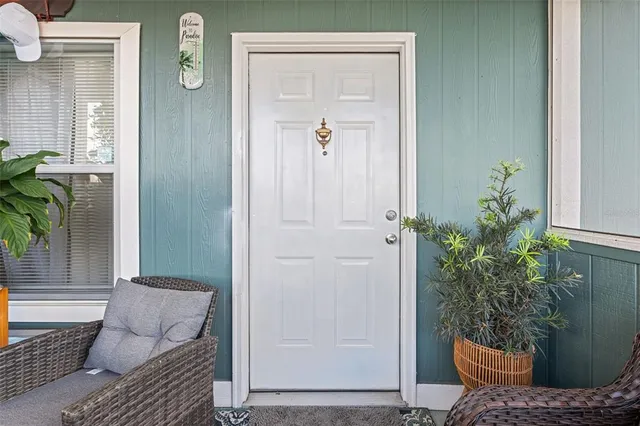 a living room with furniture a flat screen tv and a table
