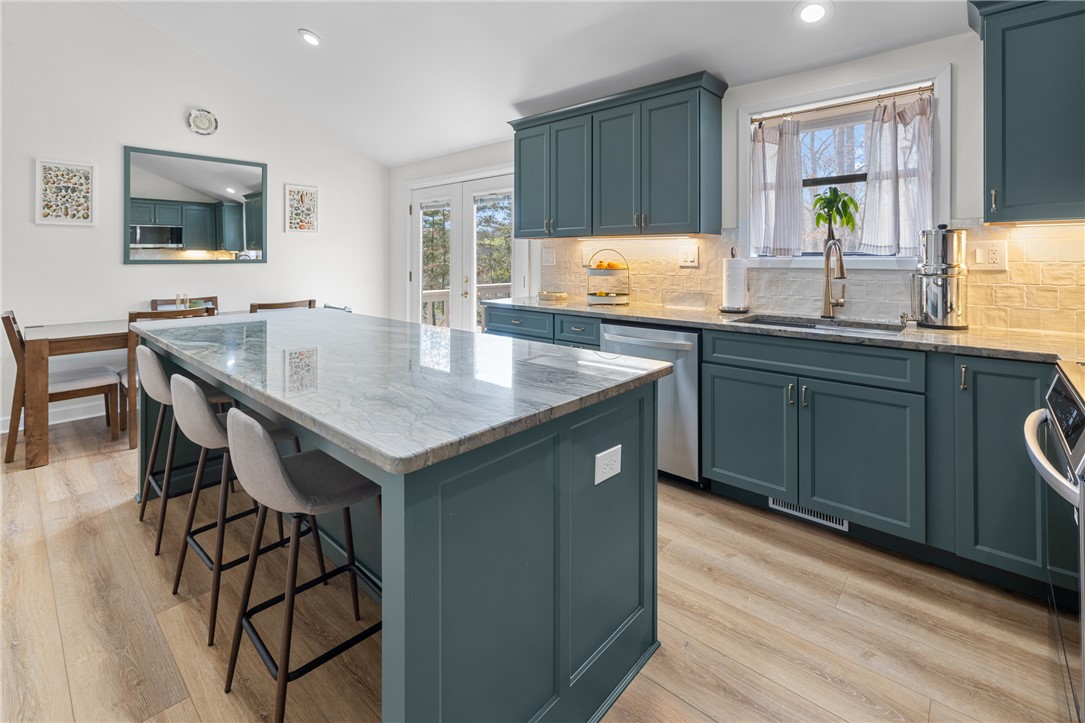 111 Shorecrest Drive Seneca, SC 29672 - Photo 2 of 35 This modern kitchen features a spacious island and bright cabinetry, perfect for culinary adventures and gatherings.