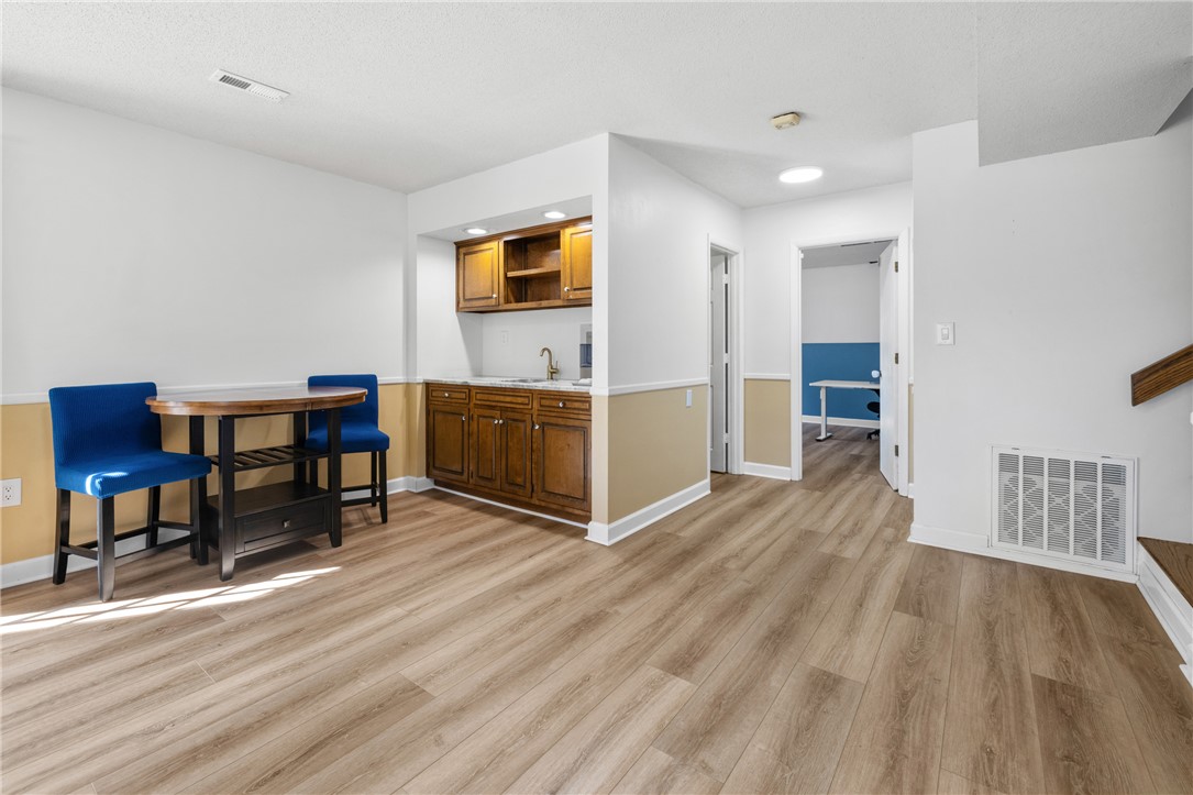 111 Shorecrest Drive Seneca, SC 29672 - Photo 22 of 35 This versatile space features durable flooring and a convenient wet bar, perfect for entertaining or daily living.