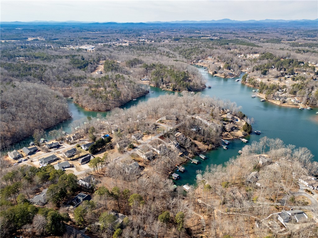 111 Shorecrest Drive Seneca, SC 29672 - Photo 32 of 35 This captivating aerial view showcases a vibrant waterfront community nestled among lush trees.