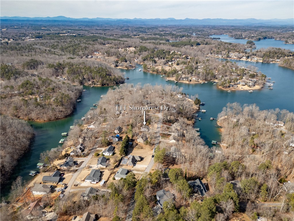 111 Shorecrest Drive Seneca, SC 29672 - Photo 33 of 35 This elevated view captures a serene lakeside community nestled among lush trees, offering tranquil waterfront living.