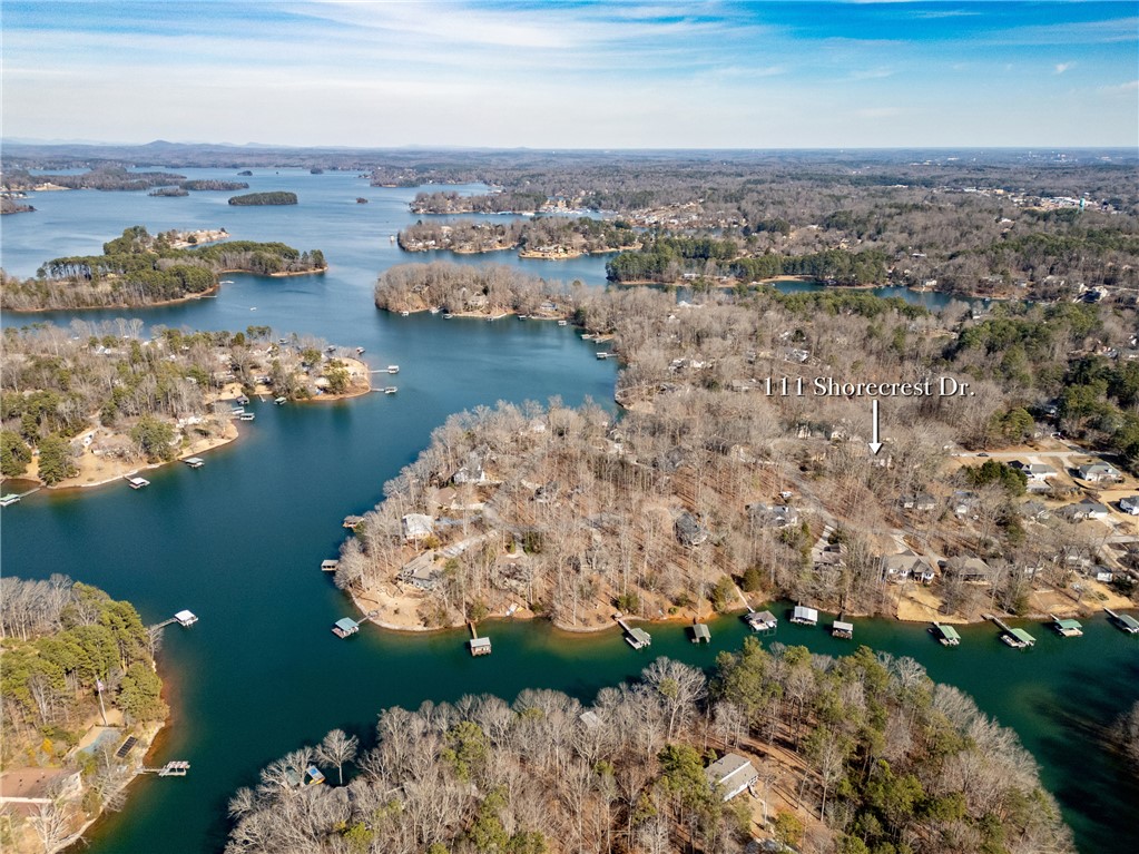 111 Shorecrest Drive Seneca, SC 29672 - Photo 34 of 35 This aerial perspective showcases a vibrant lake with lush wooded shores, highlighting serene waterfront living.
