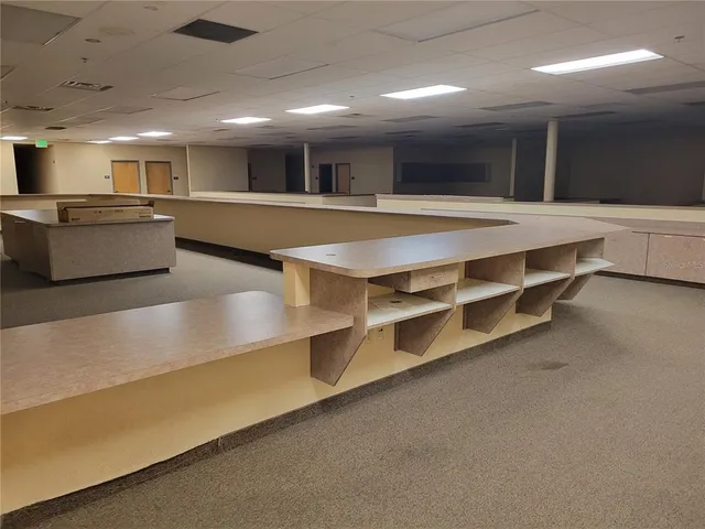 a large kitchen with stainless steel appliances a large counter top