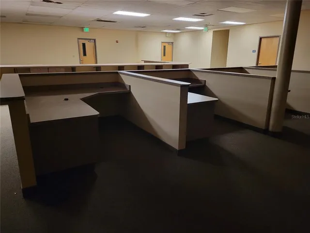 a large white kitchen with kitchen island stainless steel appliances
