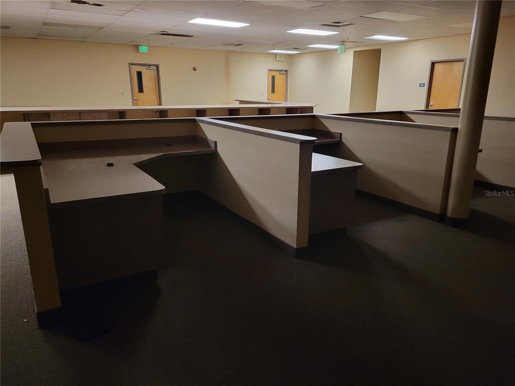 910 North Main Street, Unit 910 Bushnell, FL 33513 - Photo 8 of 8 a large white kitchen with kitchen island stainless steel appliances