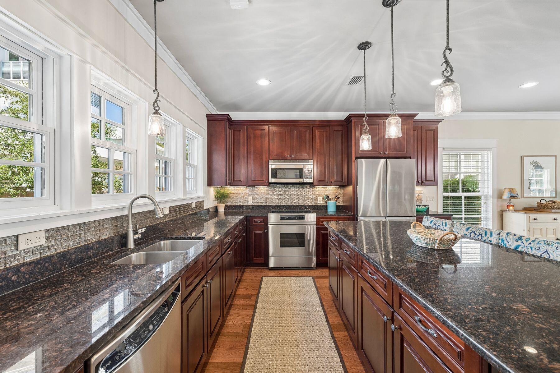 39 Willow Mist Road Inlet Beach, FL 32461 - Photo 12 of 41 a kitchen with stainless steel appliances granite countertop a sink a stove and a wooden floors